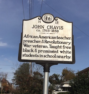 Photograph of North Carolina Highway historical marker dedicated to John Chavis. Located on Worth Street in Raleigh, NC. Reads: &quot;African American teacher, preacher, and Revolutionary War veteran. Taught free black & prominent white students in school nearby.&quot;  The marker was erected near the site of his school in Raleigh for the 100th anniversary of his death in 1938. It was the first North Carolina highway historical marker dedicated to African American history.